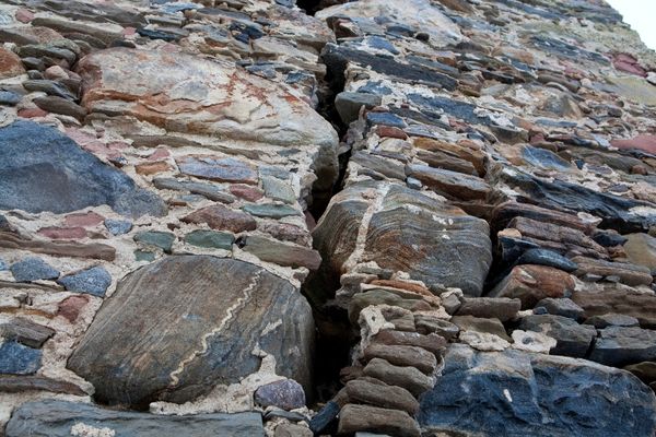 A large crack in a stone wall