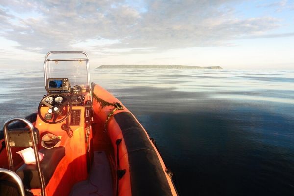 Lundy appears in the distance as Derek crosses the water in a dingy