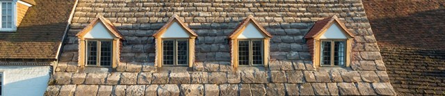 A slate roof with 3 windows