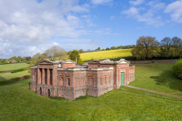 A red brick building with green doors