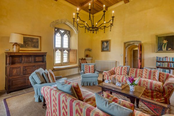 Interior living room with with yellow walls and pattern sofas