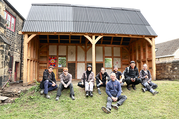 SWAP Week 3 - lime plaster panels - group in front of the timber barn and lime plaster panels