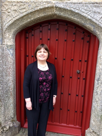 Housekeeper Carol Slade outside The College